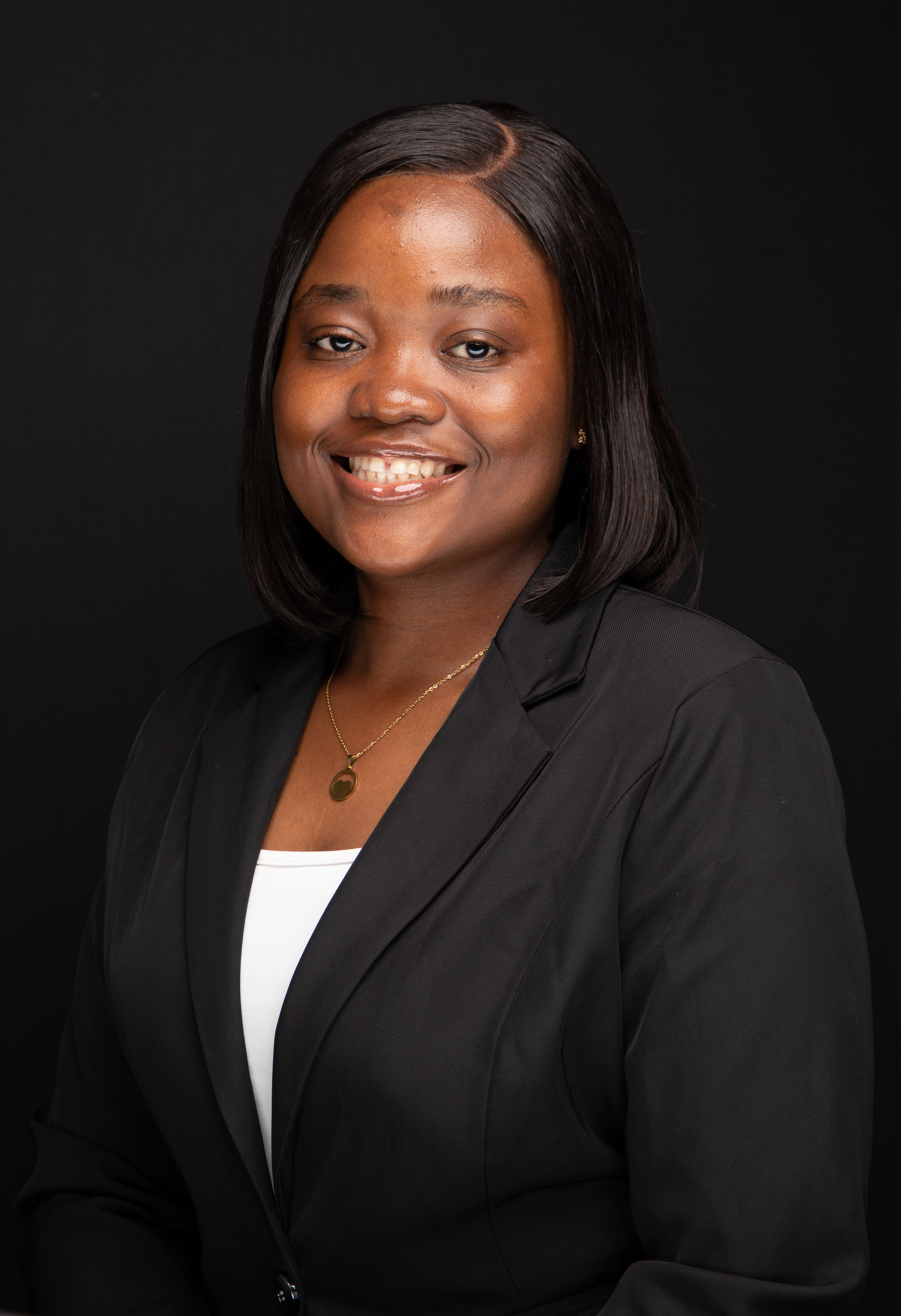 Akua Sekyiwaa smiling in a black blazer